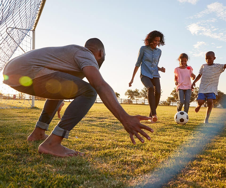 family playing soccer