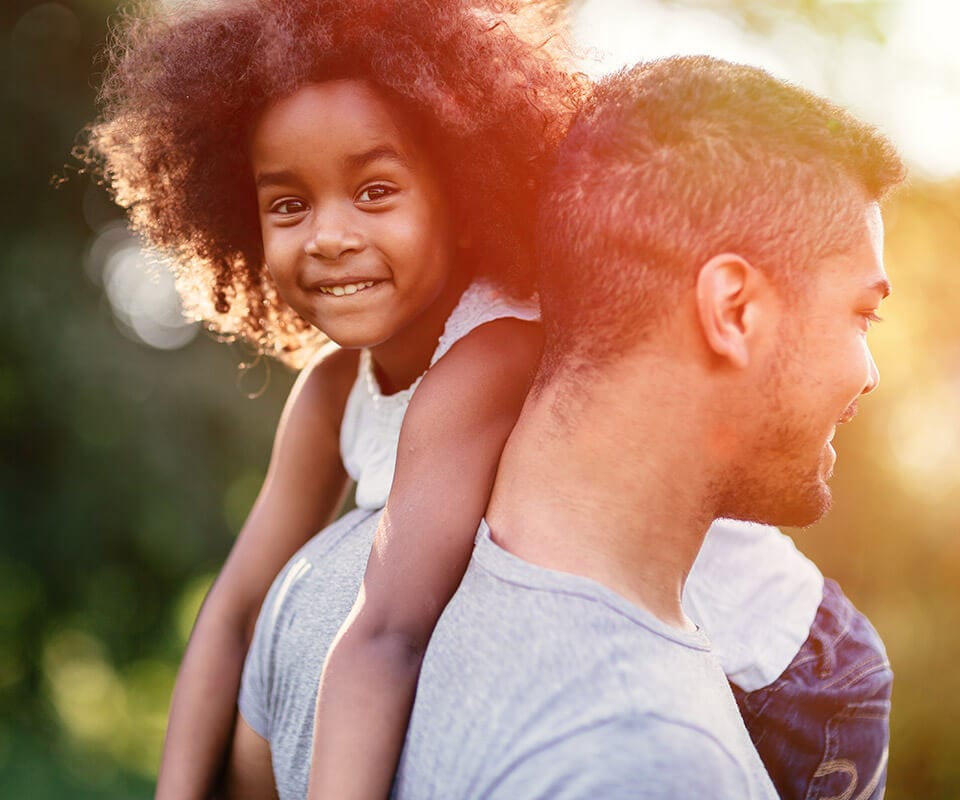 father holding daughter