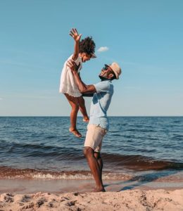 Father and daughter enjoying the beach on a sunny day