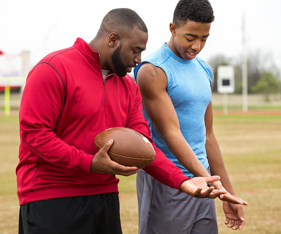 football coach with student