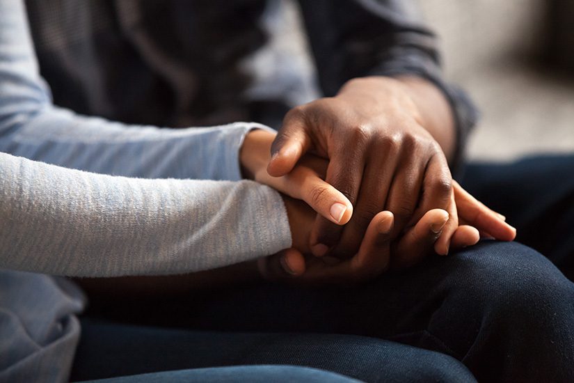 Two people holding hands
