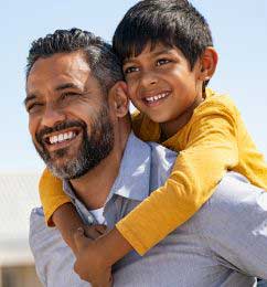 Father holding son smiling