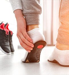 Person trying on custom orthotics