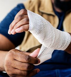 man wrapping injured hand