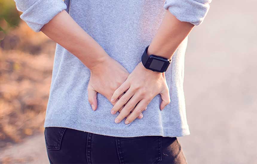 Older woman clutching her back