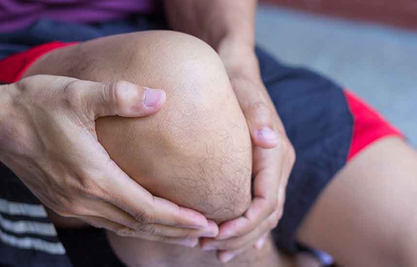 Man clutching his knee