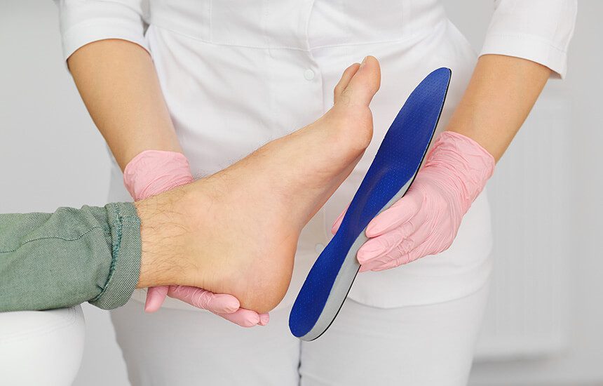 Man's foot being sized for orthodics