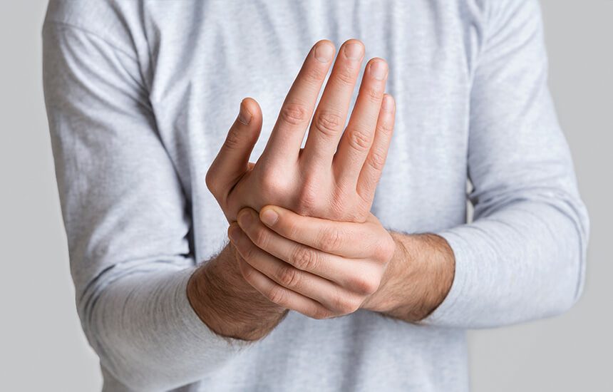 Man holding hand in pain