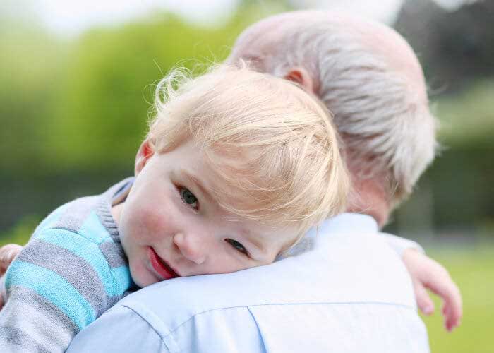 Elderly man holding small child