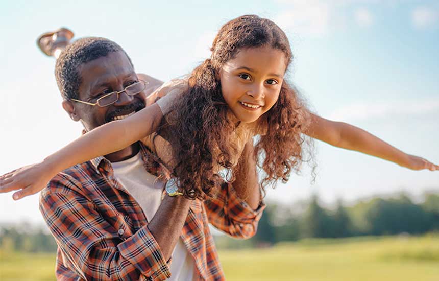 Girl being held up with arms out
