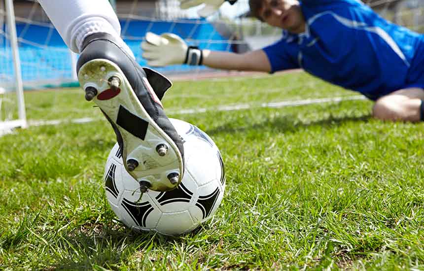Person kicking soccer ball